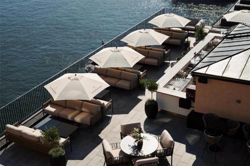 an outdoor patio with chairs and tables and umbrellas at Radisson Collection, Strand Hotel, Stockholm in Stockholm