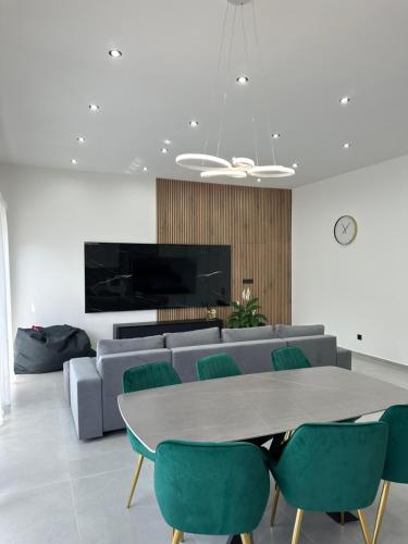 a living room with a couch and a table and chairs at Podhorský Apartmány Terchová in Terchová