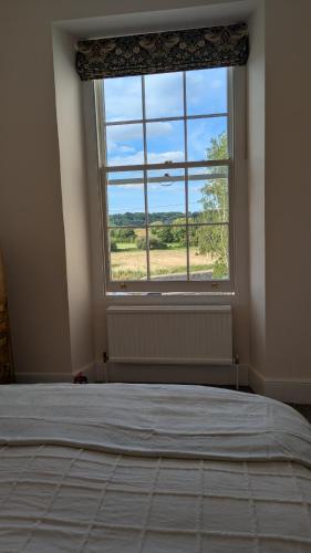 a bedroom with a bed and a large window at Hidden Gem on the Outskirts of Bristol in Keynsham