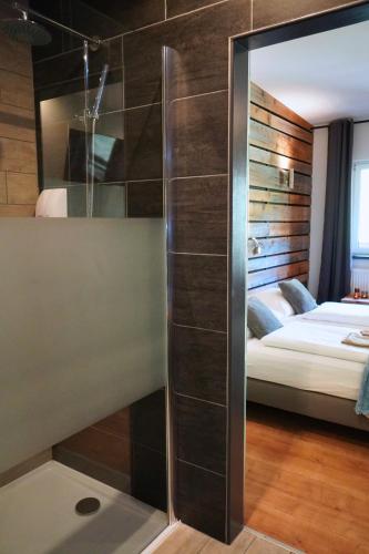 a bathroom with a mirror and a bed in a room at Pension Sonnenheim in Gmünd in Kärnten