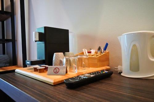 a desk with a remote control and a cup on it at Pension Sonnenheim in Gmünd in Kärnten