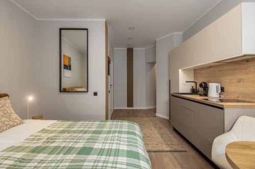 a hotel room with a bed and a kitchen at P6-A Riga Old Town Apartments in Rīga