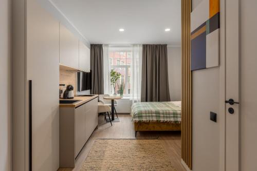 a kitchen and a bedroom with a bed in a room at P6-A Riga Old Town Apartments in Rīga