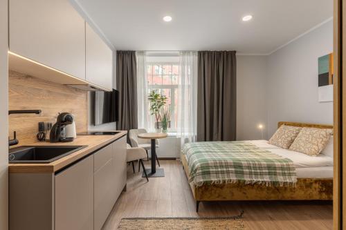 a small hotel room with a bed and a kitchen at P6-A Riga Old Town Apartments in Rīga