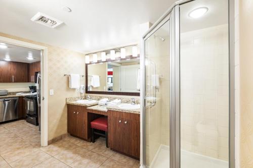 a bathroom with two sinks and a shower at The Grandview at Las Vegas in Las Vegas