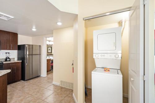 a kitchen with a refrigerator and a washer and dryer at The Grandview at Las Vegas in Las Vegas