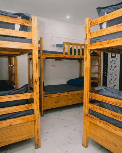a group of bunk beds in a room at Urban Loft Hostel in Rishīkesh