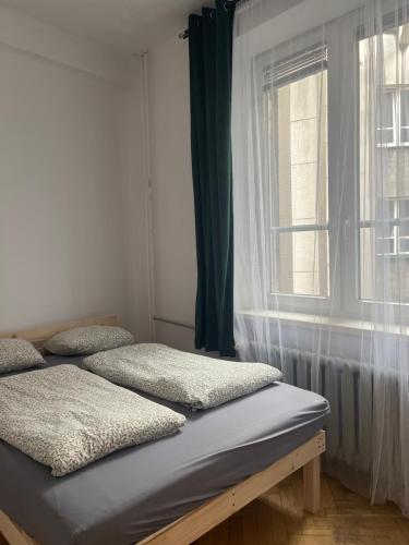 a bedroom with two beds and a window at Room in Old Town Krakow in Kraków