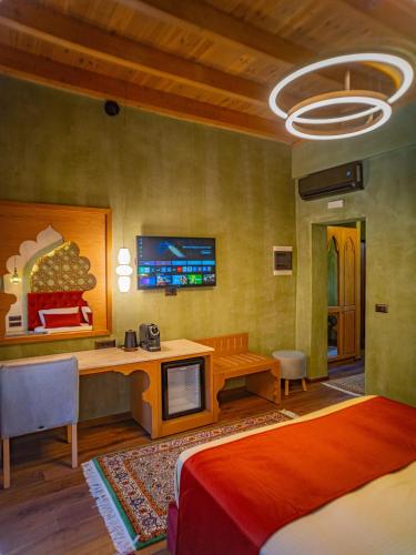 a bedroom with a bed and a desk and a tv at Fabrizio del Carretto in Rhodes Town