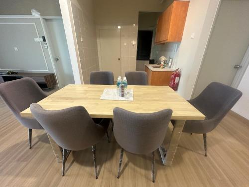 a dining room table with gray chairs around it at Cozy Condo with Scenic Views near Kuala Lumpur in Hulu Langat