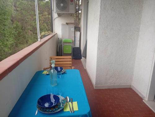 a blue table in a room with a window at Baia 55 in Lido di Spina