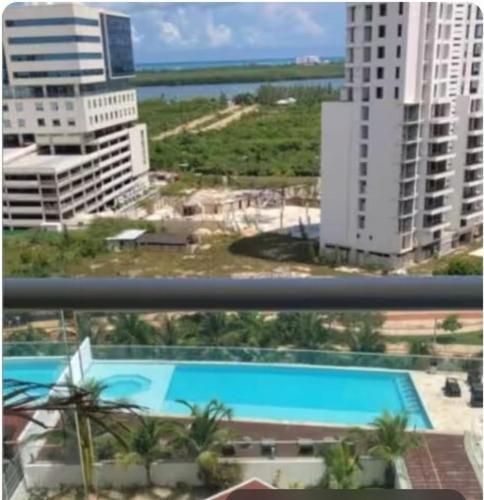 an overhead view of a swimming pool in a city at Lovely loft with pool in center! in Cancún