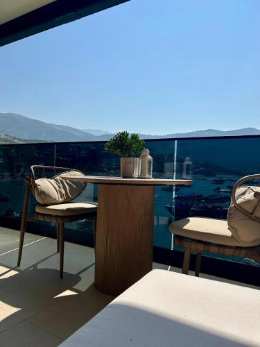 a table and two chairs on a balcony with a view at Rea Boutique Hotel in Himare