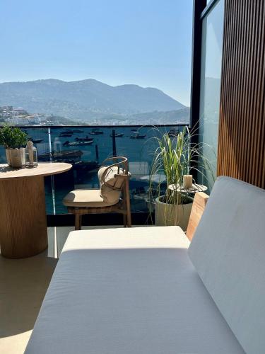 a balcony with a table and a view of the ocean at Rea Boutique Hotel in Himare