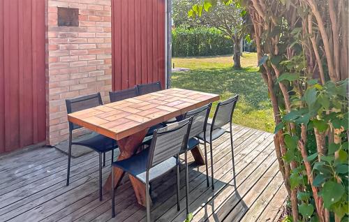 a wooden table and chairs on a deck at 2 Bedroom Stunning Home In Klintehamn in Klintehamn