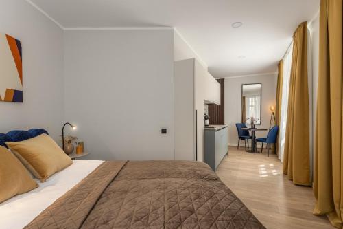 a bedroom with a large bed and a kitchen at P6-A Riga Old Town Apartments in Rīga