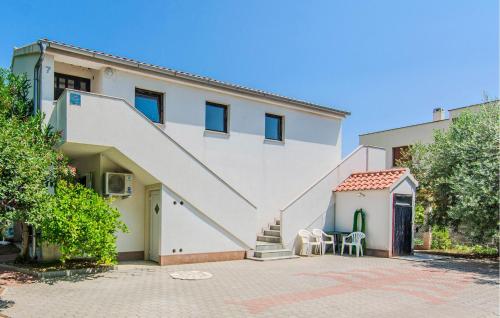 a white house with a staircase on it at Cozy Apartment In Nin With Wifi in Nin