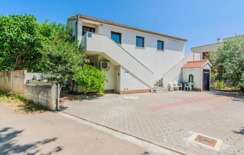 a house with a staircase in front of it at Cozy Apartment In Nin With Wifi in Nin