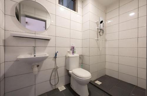 a bathroom with a sink and a toilet and a mirror at Serene Japandi Family Retreat 2-6 pax& Sunrise View in Brinchang