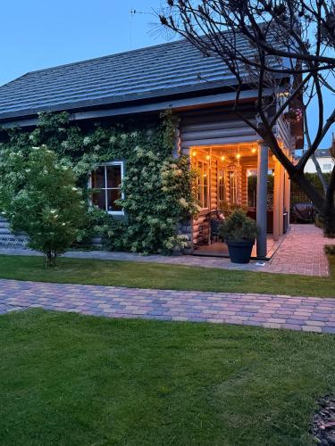 a house with lights on the front of it at Rasos Vila in Palanga