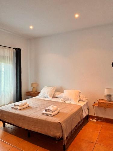 a bedroom with a bed with two towels on it at CASA RURAL Cigarral del Pintor in Toledo