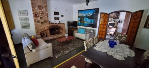 a living room with a couch and a fireplace at Pousada Pe da Serra in Tiradentes