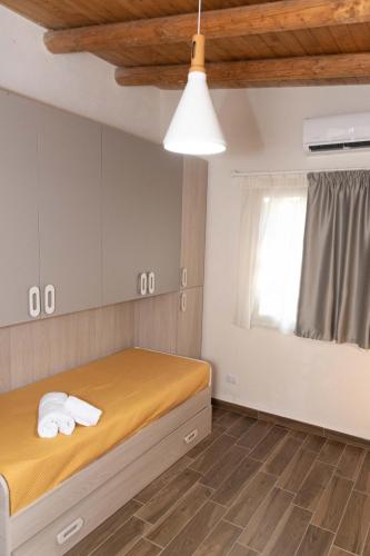 a bedroom with a bed with towels on it at Villa dei Mandorli in Naro