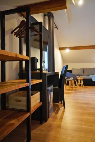 a room with a loft with a couch and a table at Pension Sonnenheim in Gmünd in Kärnten