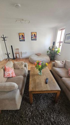 a living room with two couches and a coffee table at Spacious 3-Bedroom Apartment in Vibrant Dublin 8 in Dublin