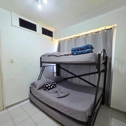 a room with two bunk beds in a room at Tucacas, Frente al Mar, Vista 180 Grados, Piscina y Playa Privada in Tucacas