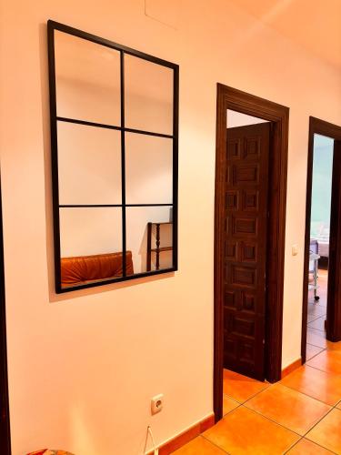 a mirror on a wall next to a door at CASA RURAL Cigarral del Pintor in Toledo
