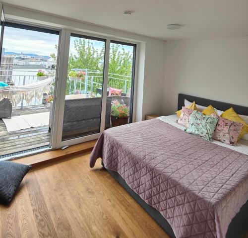 a bedroom with a bed and a large window at Apartment with a terrace in Vienna