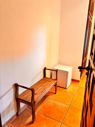 a bench sitting in the corner of a room at CASA RURAL Cigarral del Pintor in Toledo