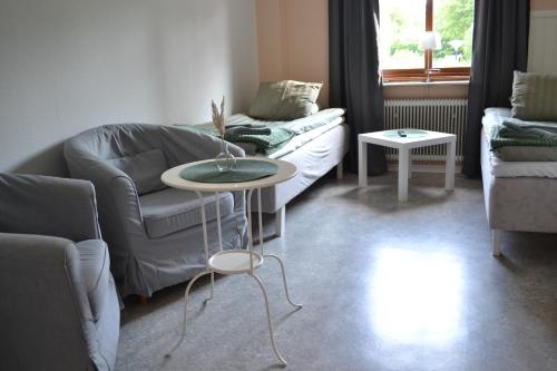 a living room with a couch and a table at Tostarps Pensionat in Hässleholm