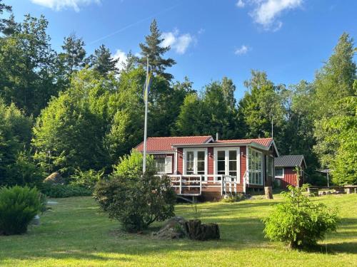 a small house in the middle of a field at Magical hide-away in the forest in Trensum
