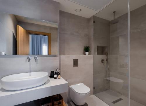 a bathroom with a sink and a toilet and a shower at Tayo Studios & Apartments in Bat Yam