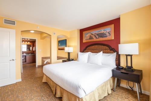 a bedroom with a large bed and two lamps at The Grandview at Las Vegas in Las Vegas
