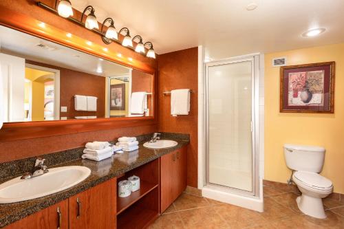 a bathroom with a sink and a toilet and a mirror at The Grandview at Las Vegas in Las Vegas