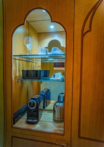 a cupboard with a kitchen with a coffee maker in it at Fabrizio del Carretto in Rhodes Town