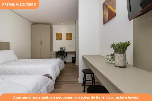 a hotel room with two beds and a desk at Century Park by My Way in Porto Alegre