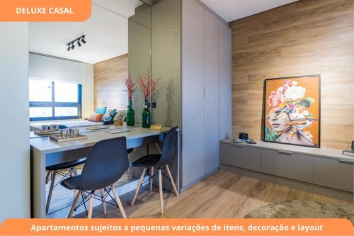 a kitchen with a table and chairs and a painting on the wall at Century Park by My Way in Porto Alegre