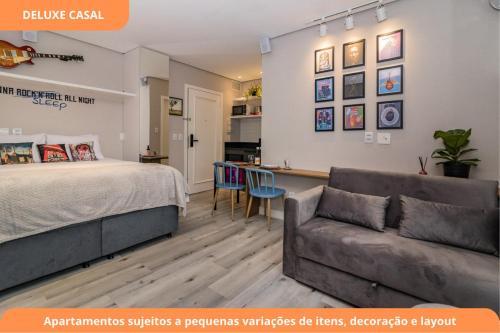 a bedroom with a bed and a couch at Century Park by My Way in Porto Alegre
