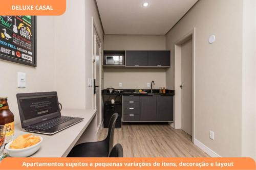 a kitchen with a desk with a laptop on it at Century Park by My Way in Porto Alegre