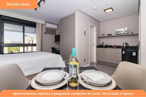 a room with a bed and a table with plates on it at Century Park by My Way in Porto Alegre