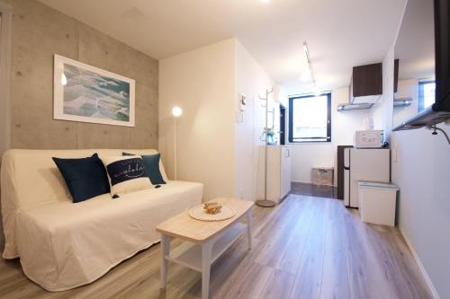 a bedroom with a bed and a table in a room at TOMALCO INN NAKANO 2 3F Flat 2 Bath 13 min to Shinjuku from Honancho in Tokyo