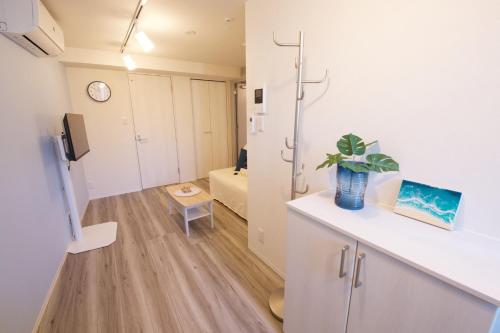 a room with a counter with a plant on it at TOMALCO INN NAKANO 2 3F Flat 2 Bath 13 min to Shinjuku from Honancho in Tokyo