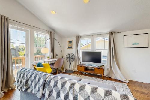 a living room with a couch and a television at New Portland Neighborhood Studio in Portland