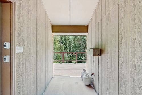 a hallway with a room with a door and a window at Elephant Mountain Cabin at Filoha Meadows in Redstone