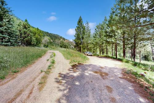 a dirt road with a car parked on the side at Elephant Mountain Cabin at Filoha Meadows in Redstone