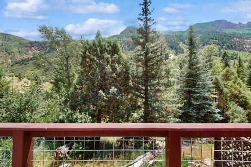 a view of the mountains from a wooden bench at Elephant Mountain Cabin at Filoha Meadows in Redstone
